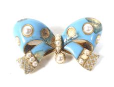 A Victorian gold, turquoise enamel and half-pearl bow brooch.