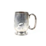 A silver christening mug.