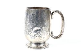 A silver christening mug.