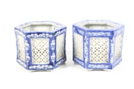 A pair of 20th century blue and white hexagonal reticulated 'cricket' pots or lanterns.
