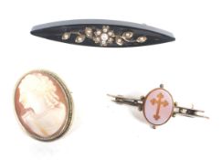 A Victorian gold, black-onyx, gold anf half pearl brooch and two other brooches.