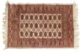 An early 20th century silk rug with 3 x 9 boteh both in buff, light red and brown colours etc.