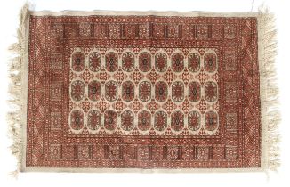 An early 20th century silk rug with 3 x 9 boteh both in buff, light red and brown colours etc.