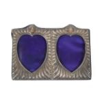 A Victorian silver-mounted double-hearts photograph frame.