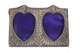 A Victorian silver-mounted double-hearts photograph frame.