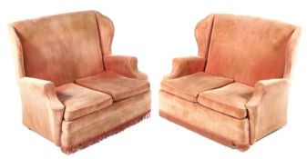 A pair of early 20th century George II style wingback sofas of two seat form. 98.