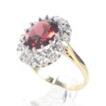 A mid-20th century gold, garnet and diamond oval cluster ring.
