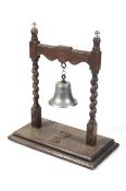 An early to mid-20th century oak and chromium ships bell on stand.