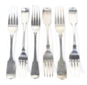 Six various George III and later silver fiddle pattern table forks.