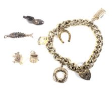 A vintage 9ct gold curb link 'charm' bracelet.