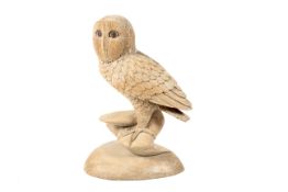 A contemporary carved wooden sculpture of a barn owl.