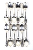 A matched set of twelve William IV and later silver fiddle, thread and shell dessert spoons.