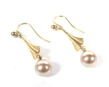 A pair of vintage gold and 6mm diameter golden-cultured-pearl single bead pendent earrings.