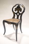 A Victorian papier mache cane seated lacquered chair with gilt decoration.