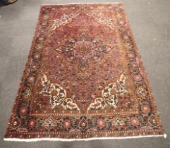 A mid-20th century hand woven woollen rug.