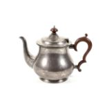 A silver baluster-shaped teapot.