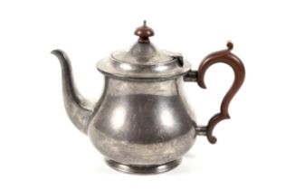 A silver baluster-shaped teapot.