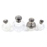 A group of four Victorian and later silver mounted clear cut-glass globular scent bottles.