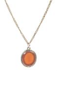 A vintage gold necklace and carnelian pendant.