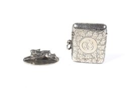 A silver hare-shaped place holder and a vesta/match case.