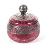 A Vintage silver mounted mottled-red glass dressing table jar and cover.