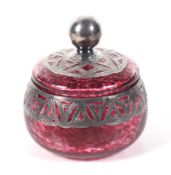 A Vintage silver mounted mottled-red glass dressing table jar and cover.
