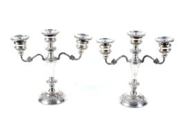 A pair of silver two branch/three light candelabra.