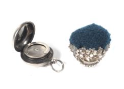 A Victorian silver sovereign case and a pin cushion.