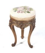 A Victorian walnut piano stool of circular form.