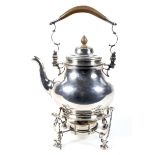 A silver baluster shaped tea kettle on stand in George II style.