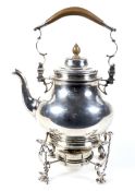 A silver baluster shaped tea kettle on stand in George II style.