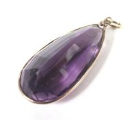 A vintage gold and pear-shaped amethyst pendant.