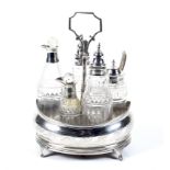 A George III silver oval cruet stand and five silver mounted bottles.