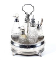 A George III silver oval cruet stand and five silver mounted bottles.