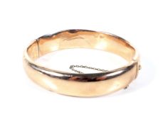 An early 20th century rose gold hollow half-hoop bangle.