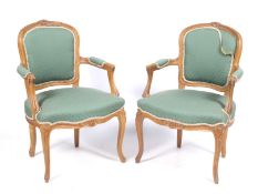 A pair of armchairs with fluted and carved details.