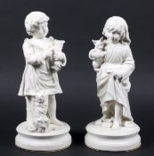 A pair of Parian ware figures of children.