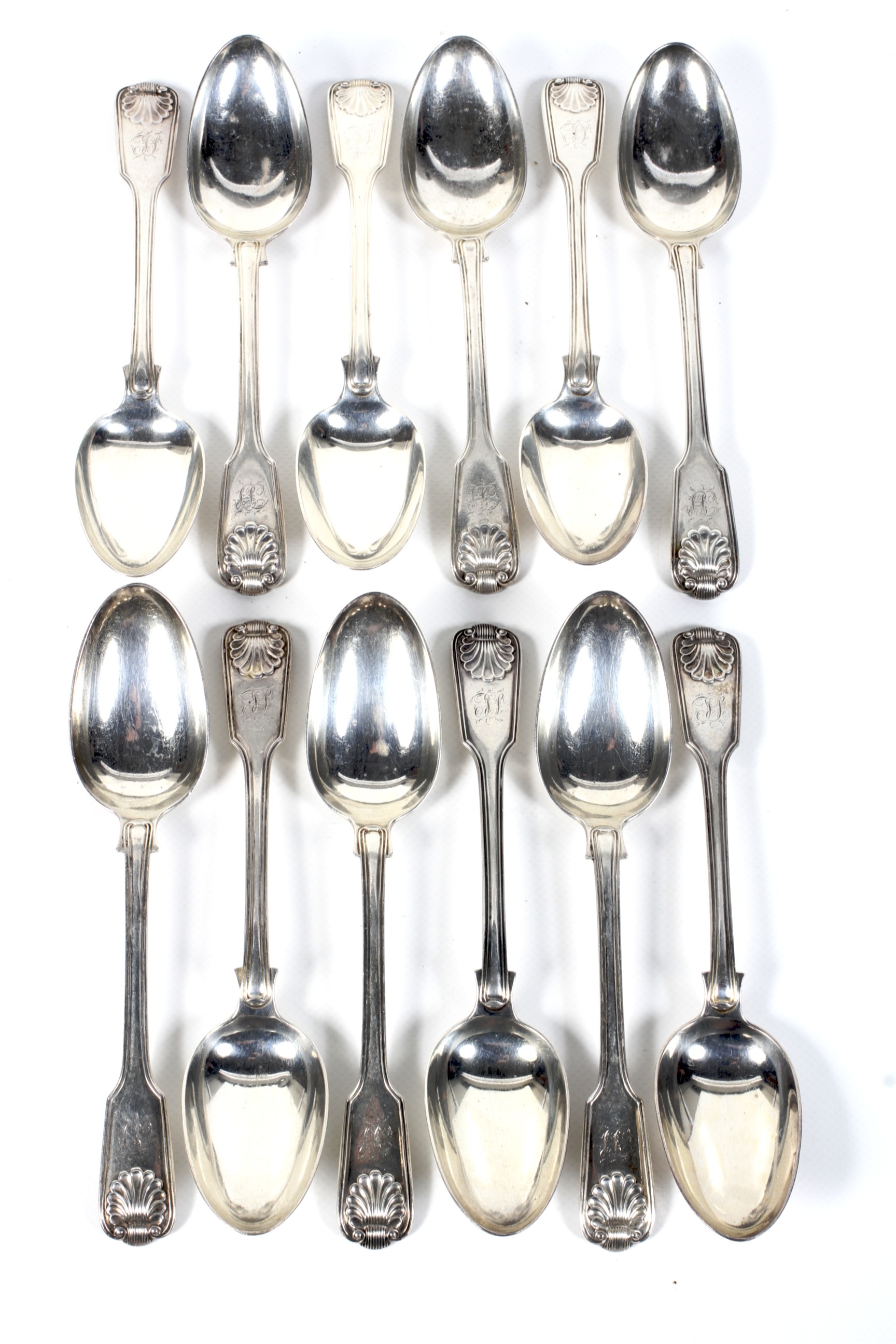 A matched set of twelve William IV and later silver fiddle, thread and shell table spoons.