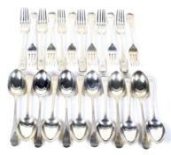 Two sets of six silver old English pattern dessert forks and spoons.