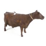 A rusty cast metal cow.