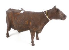 A rusty cast metal cow.