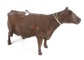 A rusty cast metal cow.