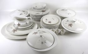 A Royal Doulton bone china dinner service in the 'Tumbling Leaves' pattern.