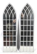 A pair of 'Gothic' arch top wall mirrors.