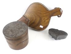 A wooden pot and cover, a pair of bellows and a printing block. Max.