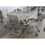 A 120cm teak garden table and four folding chairs.