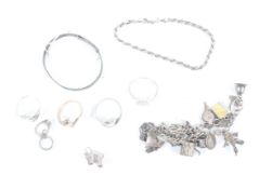 Small collection of silver and white metal jewellery including a charm bracelet