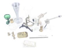 An assortment of medical equipment. Including measuring tubes, a heart monitor, sprayer, etc.