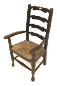 A 20th century child's ladderback carver chair.