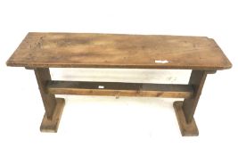 A rustic wooden bench seat.